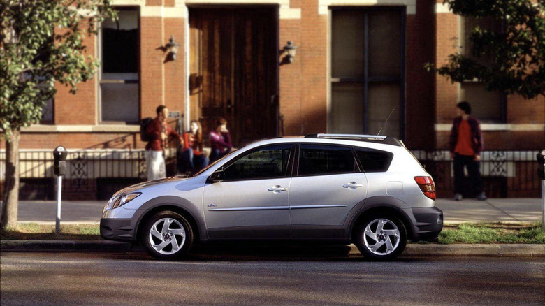 Pontiac Vibe parked in front of townhouses on a sunny street