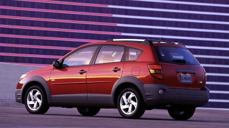 A red Pontiac Vibe parked in front of some colorful lines