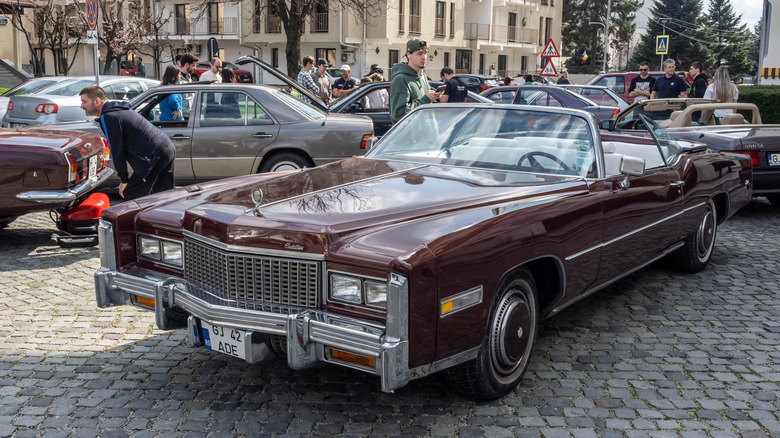 A brown Cadillac at a car show