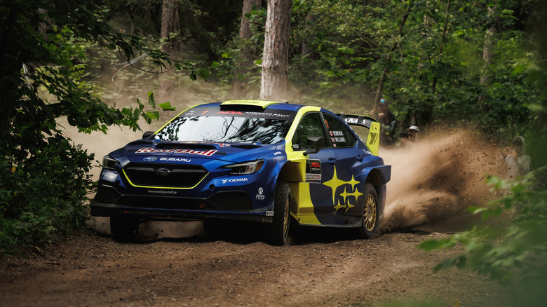 A Subaru WRC rally car drifting around a corner