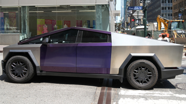 A purple-painted Tesla Cybertruck drives on East 45th Street near Lexington Avenue on July 23, 2026.