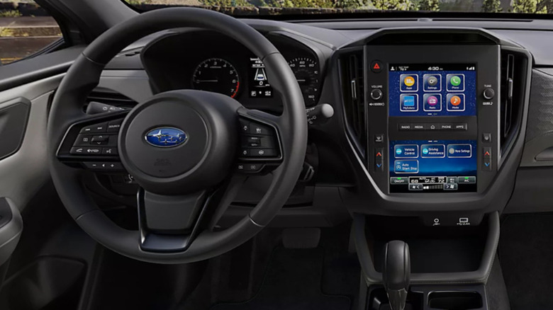 wide shot of the dash of a base Forester showing its split center infotainment screen