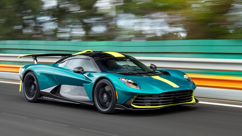 Front 3/4 view of a green Aston Martin Valhalla driving on track