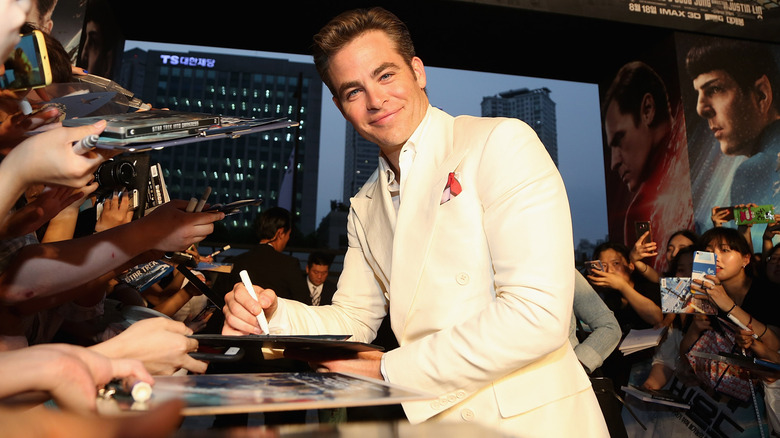 Actor Chris Pine signing autographs at a Star Trek movie premiere.