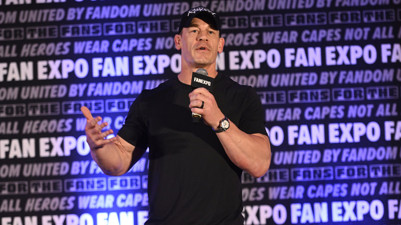 Wrestler John Cena addressing a crowd at a fan expo.