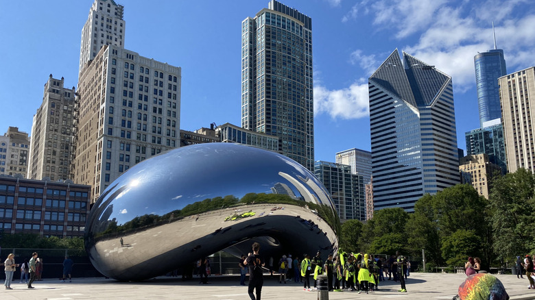 A photograph of nan Chicago Bean connected a sunny time pinch tons of group opinionated successful beforehand of it
