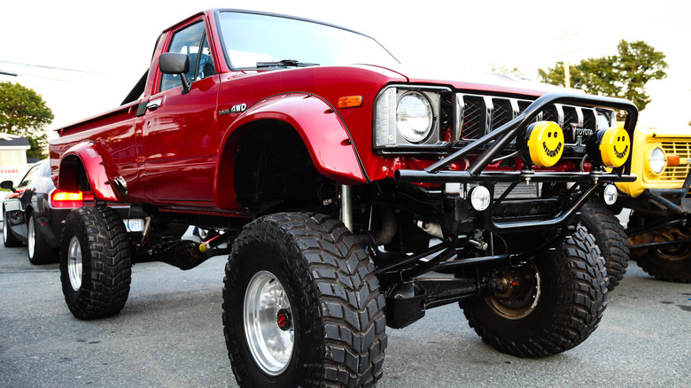 A lifted red pickup truck