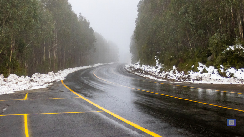 Roads cleared off snow and reflection of wet road Lake Mountain Melbourne Australia