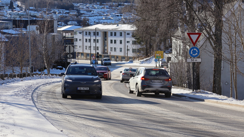 Kongsvinger, Norway - 19 february 2025: Busy cars driving in traffic on the road and in line in the roundabout