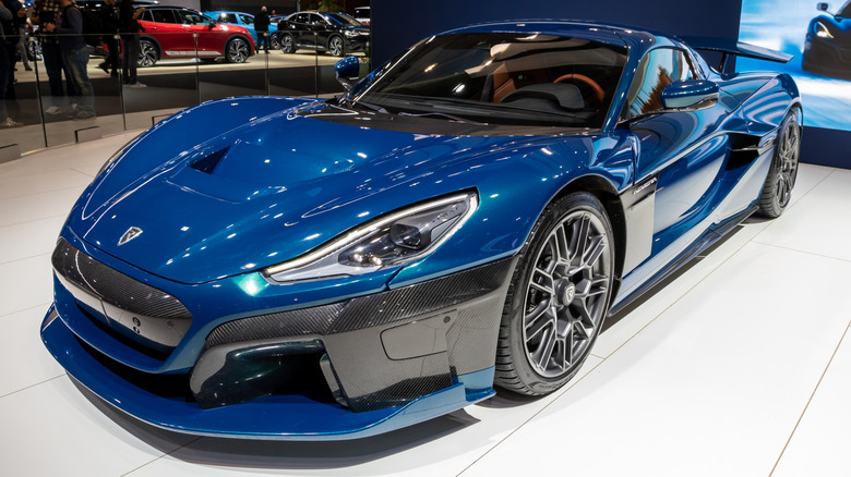 A dark blue Rimac Nevera on display at a car show.