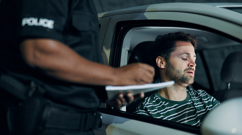A man getting fined by a police officer