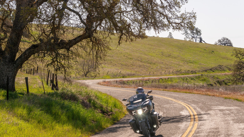 A motorcyclist on a winding country road