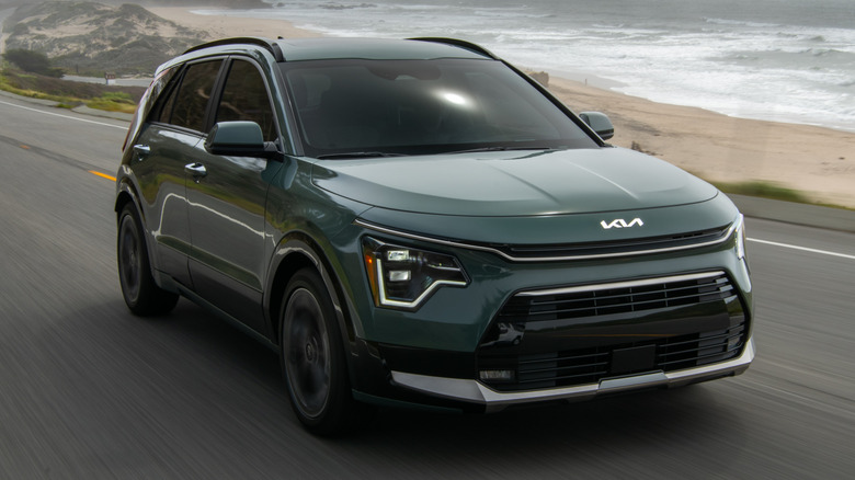 2026 Kia Niro driving along a paved coastal road