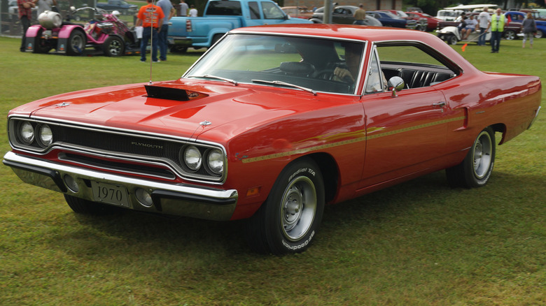 Red 1970 Plymouth Road Runner coupe seen from left front at an outdoor car show