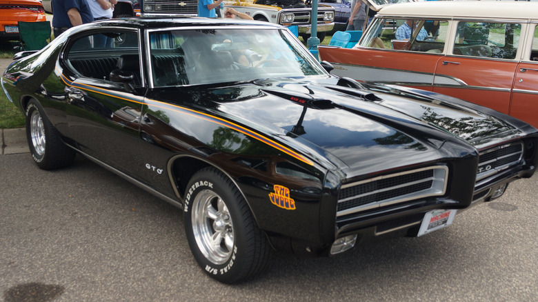 Black 1969 Pontiac GTO Judge seen from front right parked at an outdoor auto show