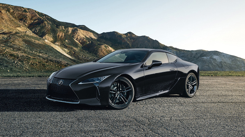 front three quarters shot of a black Lexus LC 500 parked on asphalt in front of mountains