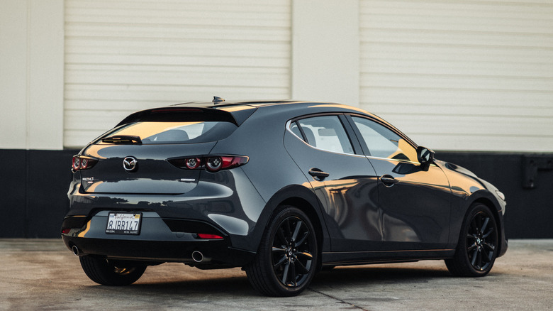 rear three quarters shot of a gray Mazda 3 hatchback