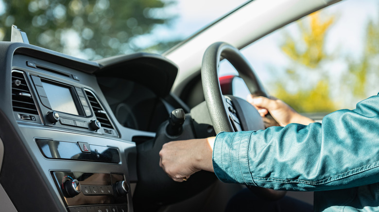 Person turning on a car key