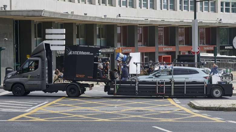 A van-mounted camera rig filming a car