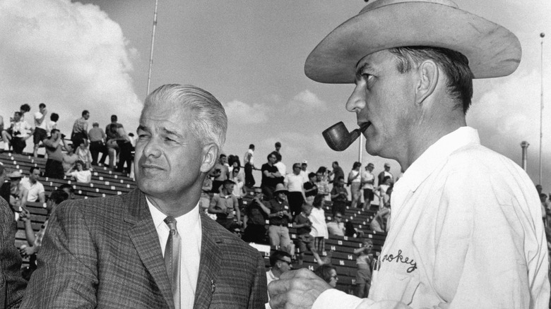 Russell DeYoung, Chairman of the Board Goodyear Tire and Rubber Co. Akron, Ohio, gets a tour around the famed 500-Mile Race Track from car builder Smokey Yunick of Daytona Beach, Florida. DeYoung made a whirlwind trip to inspect this race track to the big race to be held May 30th.