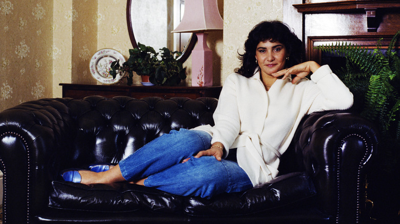 Michele Mouton, the French female World Rally Championship driver for Audi AG, poses for a photograph on a leather sofa at a hotel before competing in a rally driving the Audi Quattro in Wales, U.K., on Friday, October 14, 1983. Mouton competing in the World Rally Championship for the Audi team took four victories and finished runner-up in the drivers' world championship in 1982. (Photo by Bryn Colton/Getty Images)