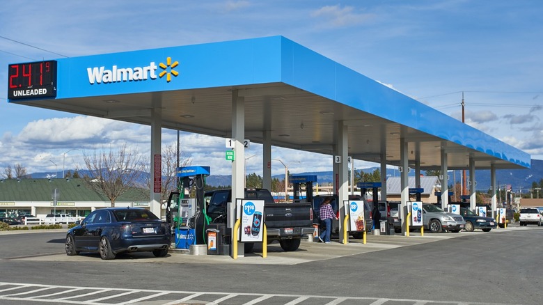 Walmart gas station with vehicles in view.