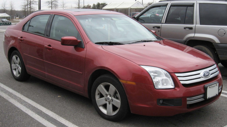 A red 2006 Ford Fusion in a parking lot