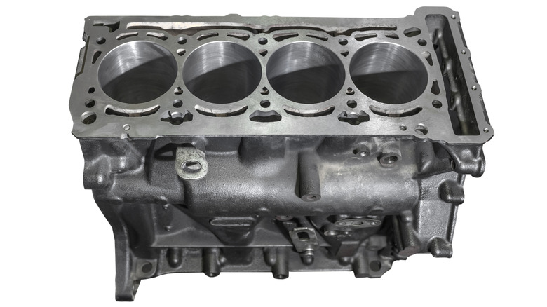 Engine block from a four-cylinder engine isolated on a white background