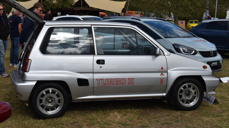 A silver Honda City Turbo II alongside a modern Honda Jazz