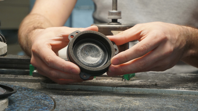 A Bentley worker holding a speaker