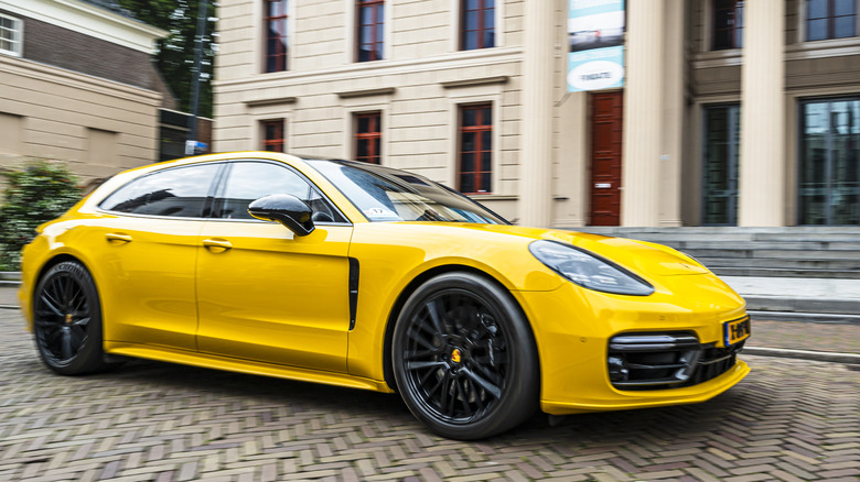 Porsche Panamera Turbo S E-Hybrid Sport Turismo driving on the street in Zwolle during a charity event.