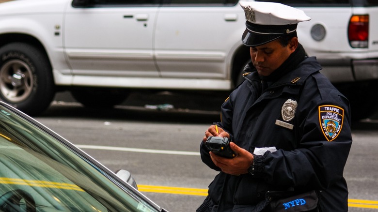 NYPD officer writing a ticket