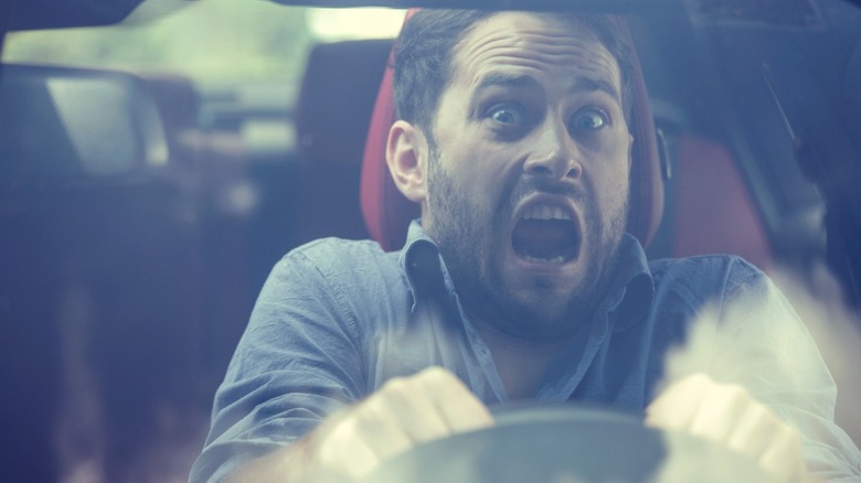Panicked male driver behind the wheel