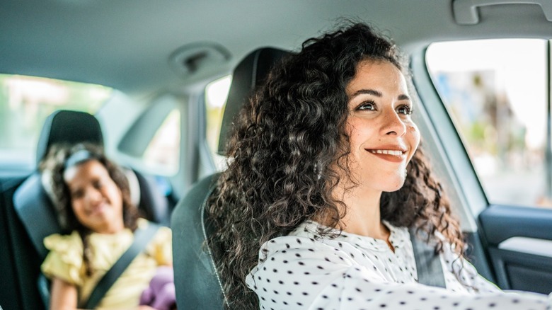 Mother in driver seat and her small daughter in the backseet