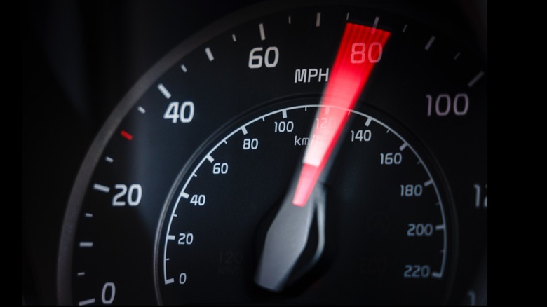 The dial of a car's speedometer passes 80.