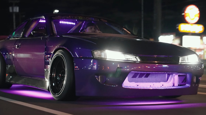 A modded car with purple LED underglow lights