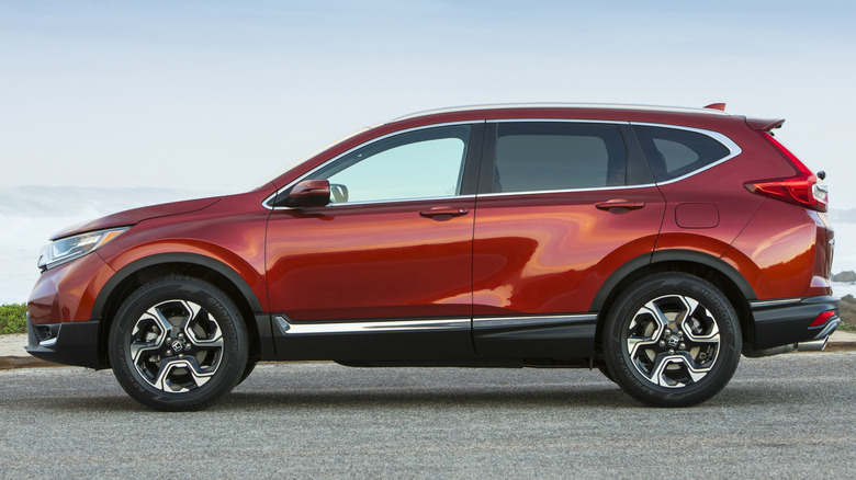 A red 2018 Honda CR-V sits parked near water.
