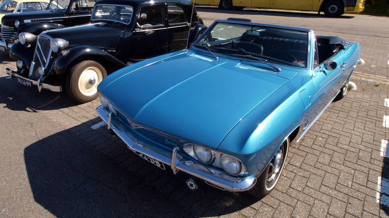 A blue 1966 Chevrolet Corvair at a car meet