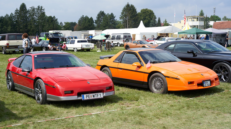A pair of Pontiac Fieros at a car meet in Austria