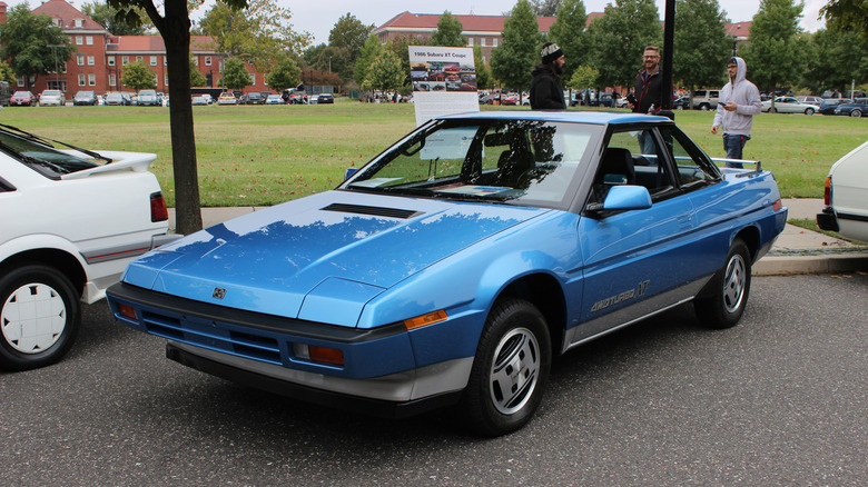 A blue 1986 Subaru XT coupe at a car show