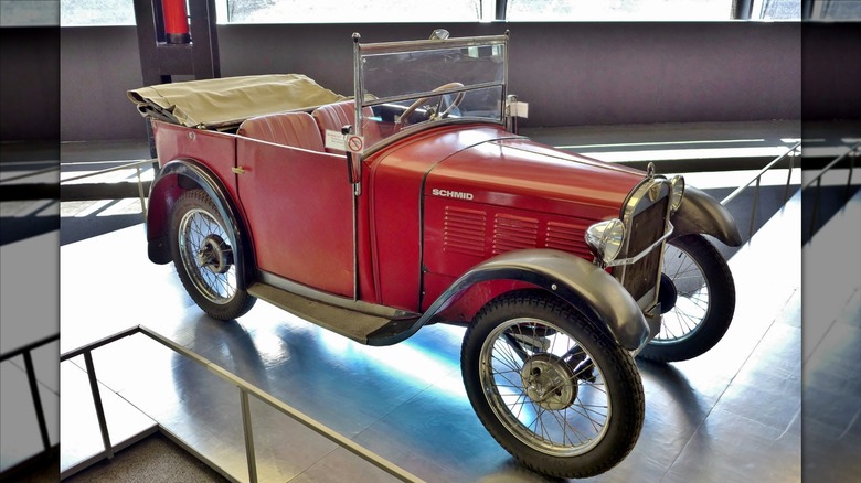 Red BMW Dixi 3/15 DA-1 convertible seen from right front three-quarter view on display in a museum