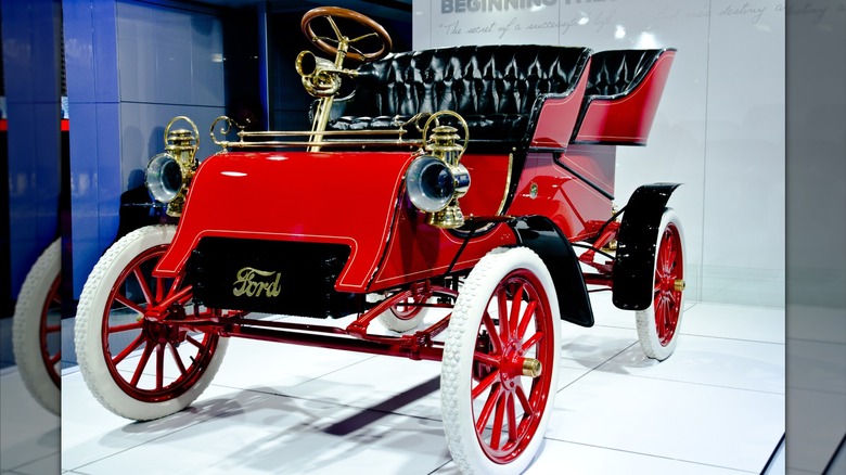 Red 1903 Ford Model A seen in left front three-quarter view on display indoors