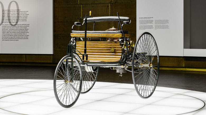 Benz Patent Motor Car three-wheeled vehicle seen in left front three-quarter view on display in a museum