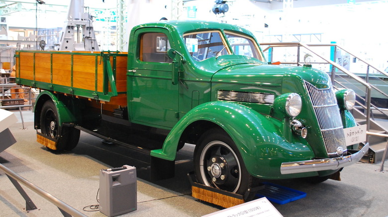 Green 1935 Toyoda G1 truck seen in right front three-quarter view on display in museum