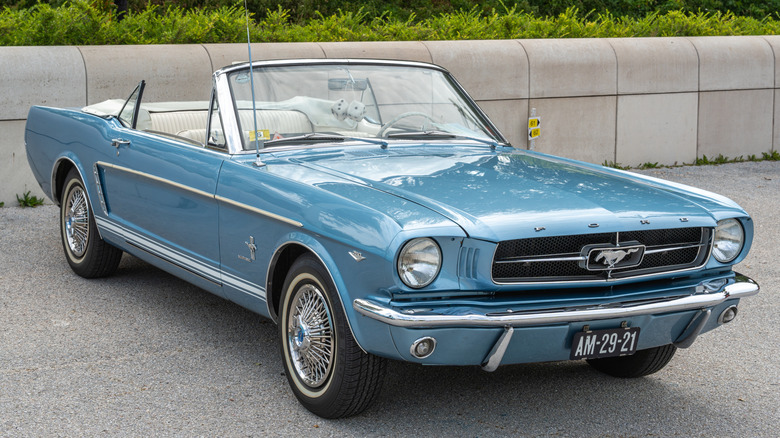 This is a 1964.5 Ford Mustang Convertible in a parking lot..