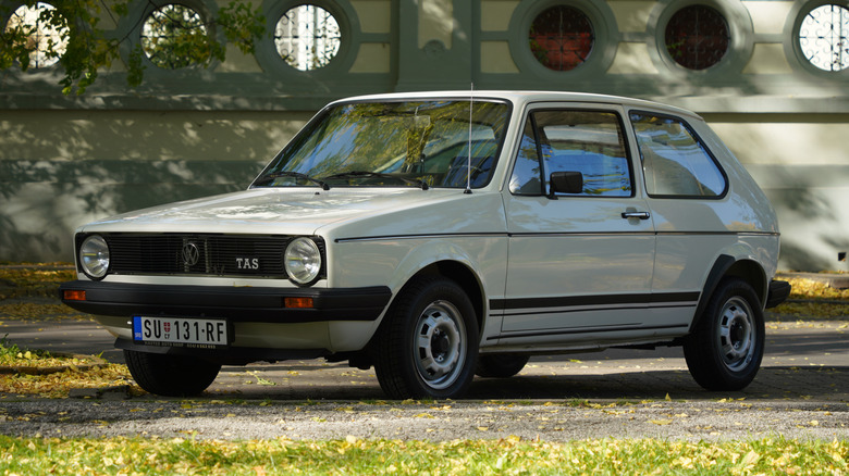 This is a 1980s Volkswagen Golf Mk1 seen in a neighborhood setting.