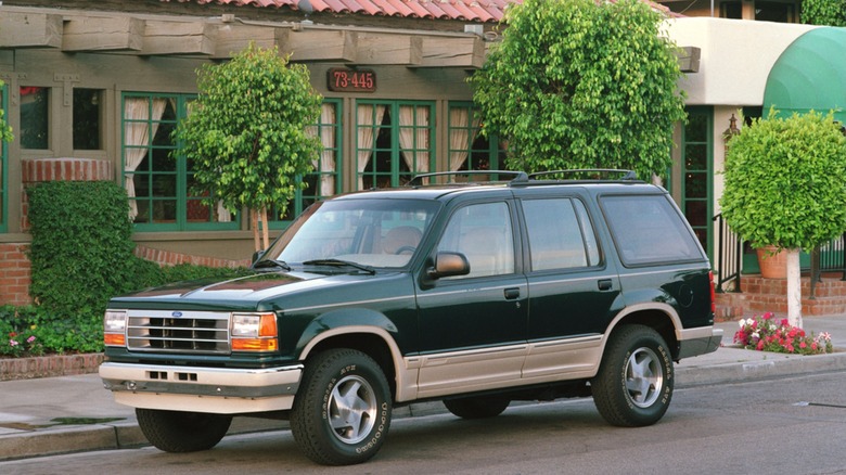 A 1991 Ford Explorer sitting in front of a restaurant.