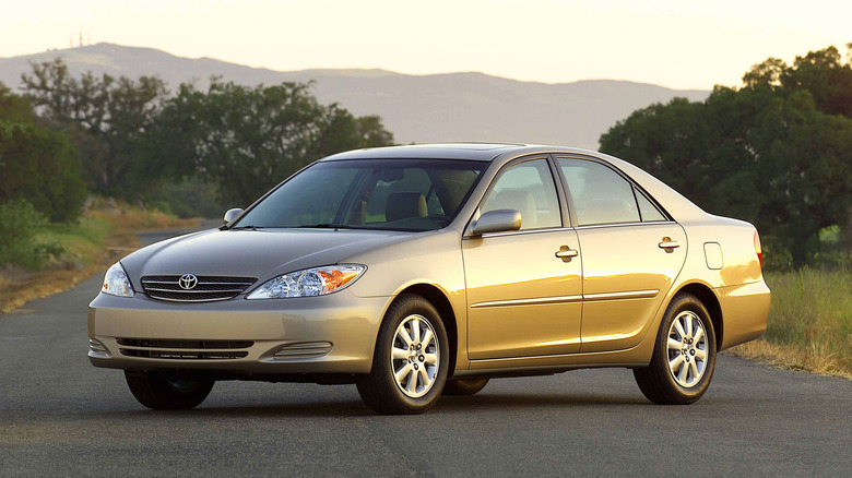 This is a 2002 Toyota Camry parked for pictures on a quiet street.
