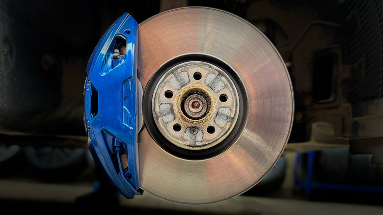 A vehicle's disc brake with a blue caliper