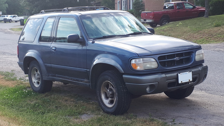 An old blue two door Ford Explorer